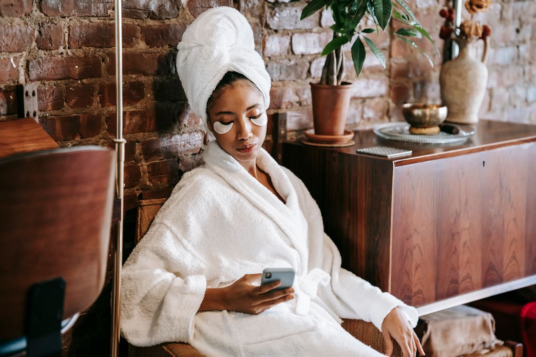 Woman on her phone at a spa appointment